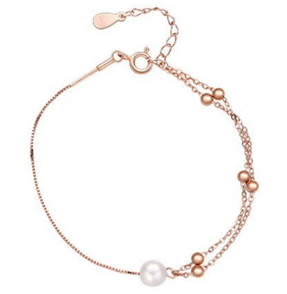 Close-up of Ada Pearl Bracelet with dual sterling silver chains, freshwater pearl, and delicate silver beads. Available in silver, 18k gold plated, and rose gold finishes.